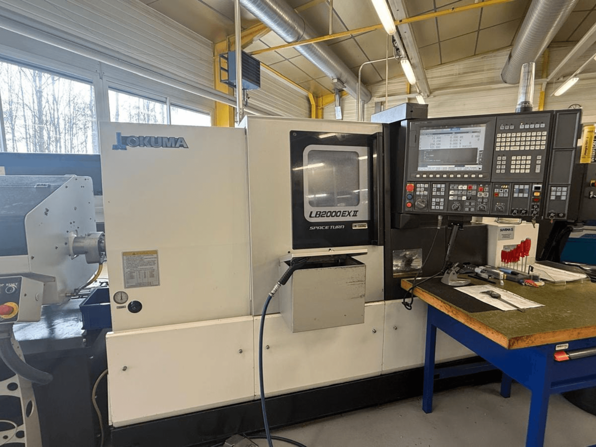 Tour horizontal Okuma LB2000EX II, vue de face ; panneau de commande, zone de la broche et espace de travail environnant.