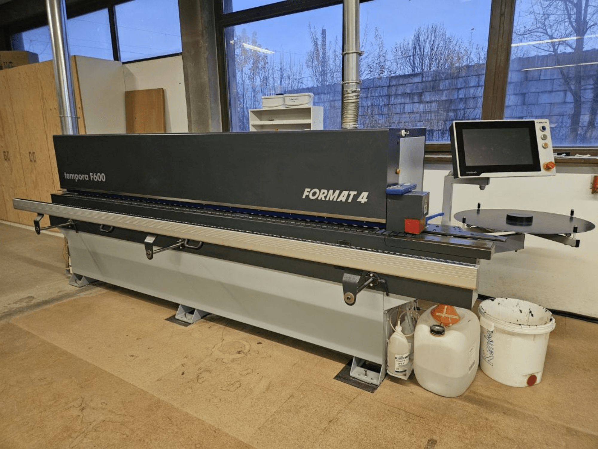 Templora F600 de Format 4, vue de face d'une machine à travailler le bois avec écran numérique, table de coupe et bacs de rangement.
