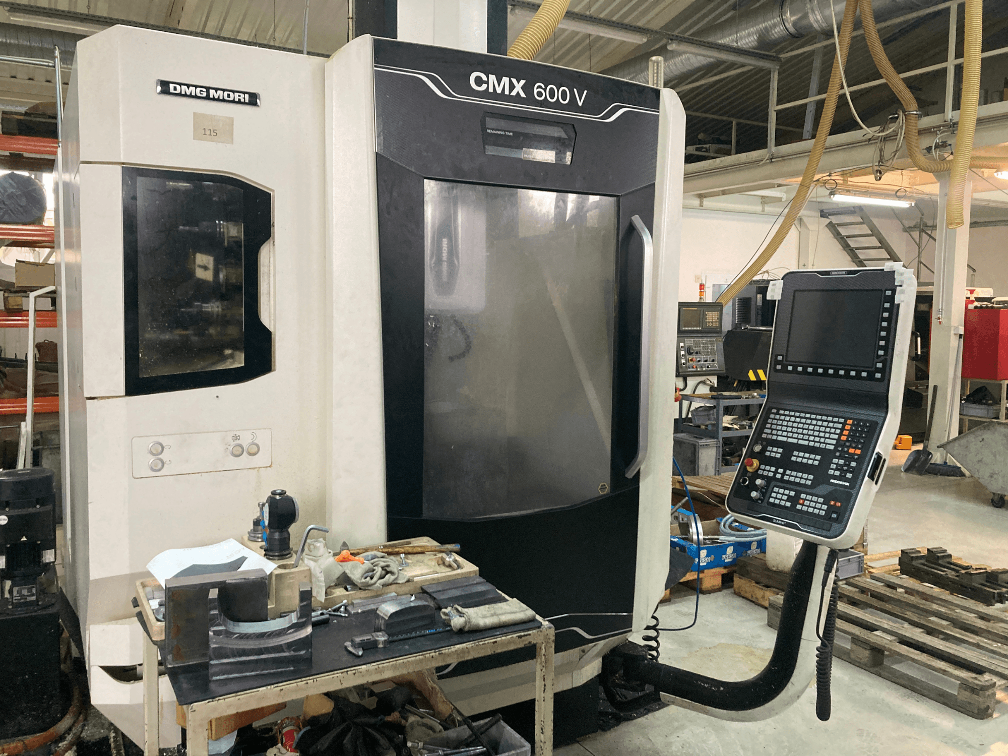 Fraiseuse DMG MORI CMX 600 V vue de face, montrant le panneau de commande et la table de travail avec les outils.