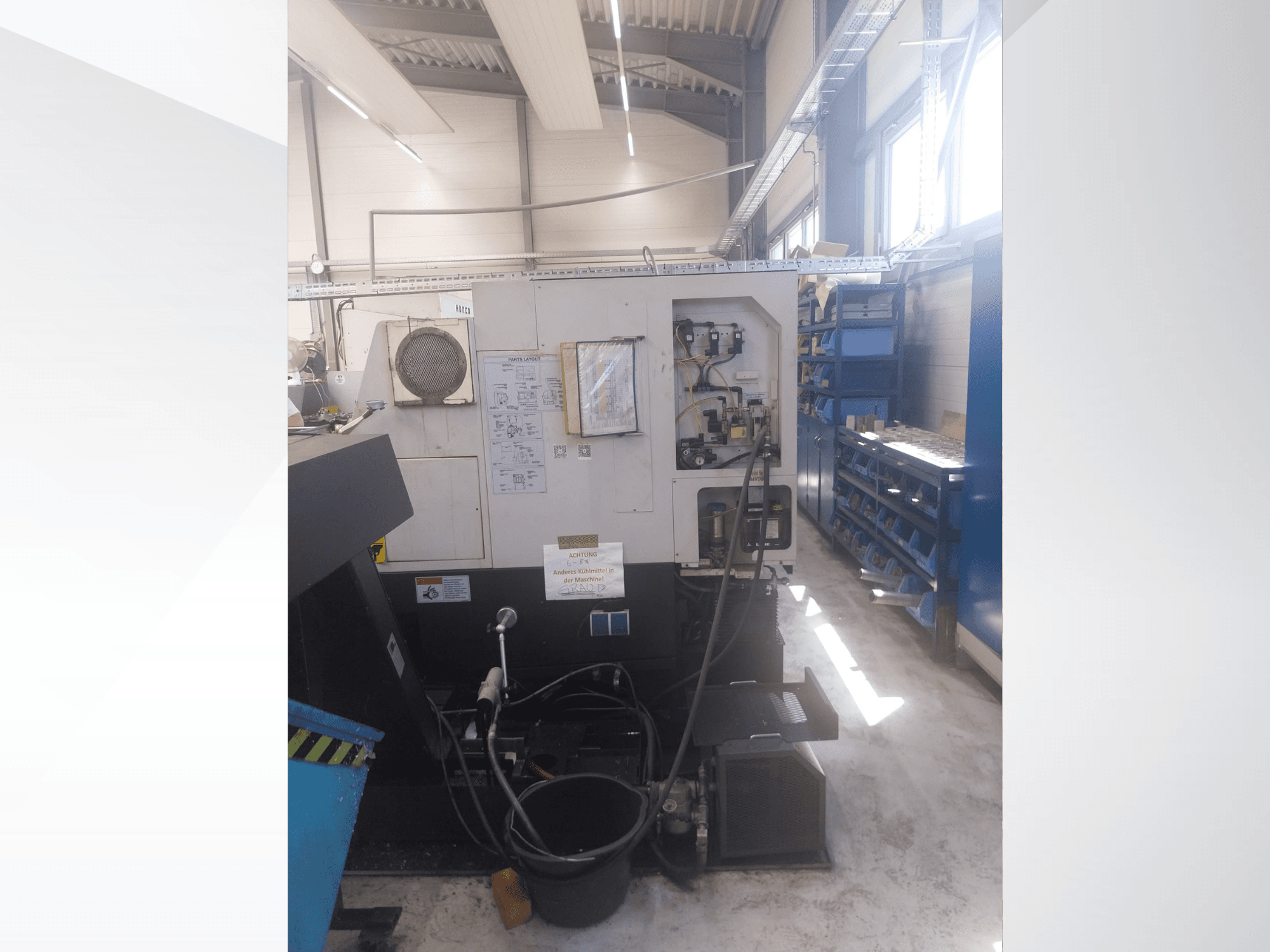 Mazak QUICK TURN NEXUS 200 MS, vue de profil montrant le panneau de commande, les flexibles et la zone d'outillage dans un atelier.