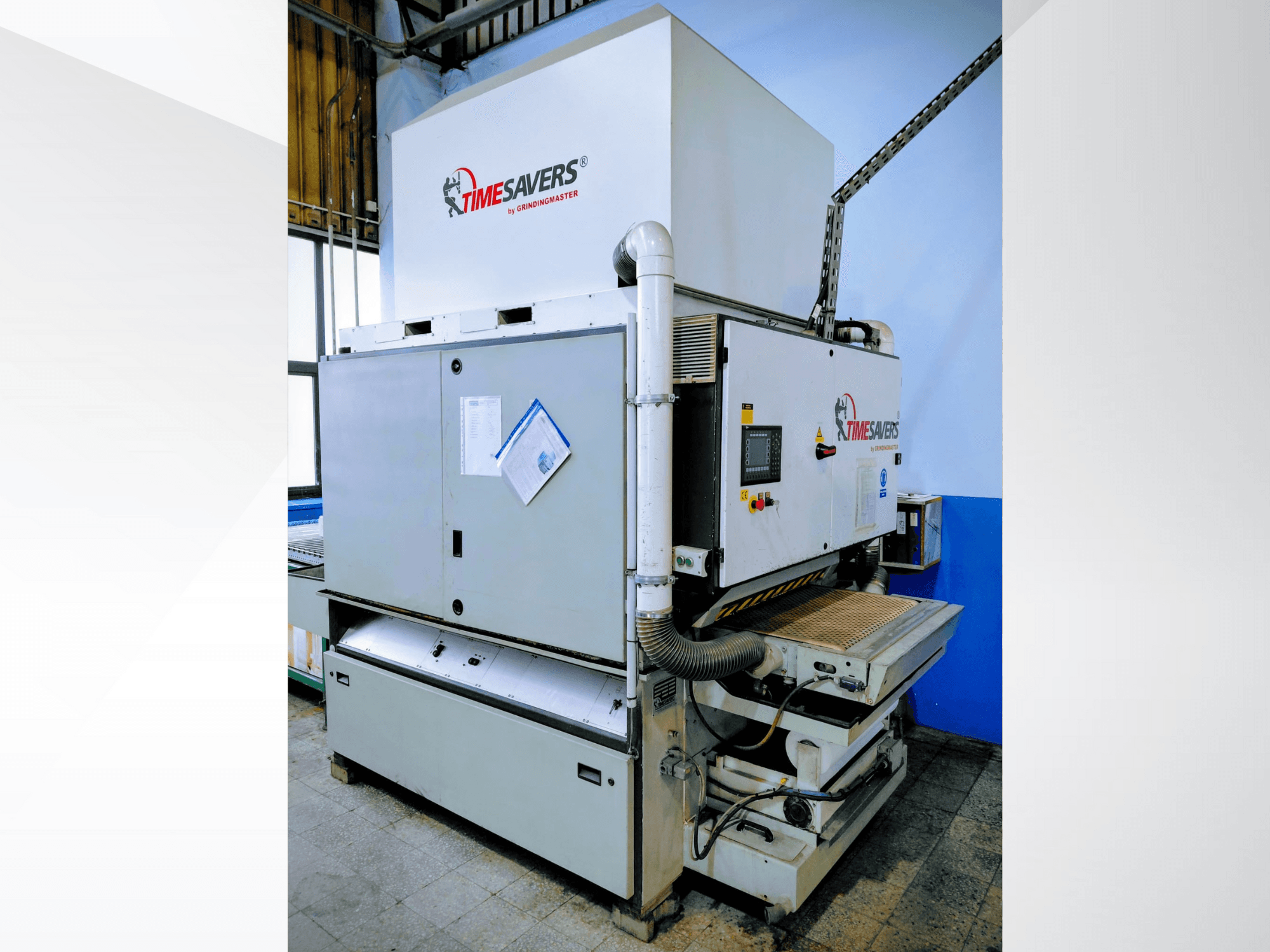 Ponceuse industrielle Timesavers, vue de face. Elle est équipée de commandes opérationnelles, d'un système d'aspiration des poussières et d'un plateau de ponçage réglable pour plus de précision.