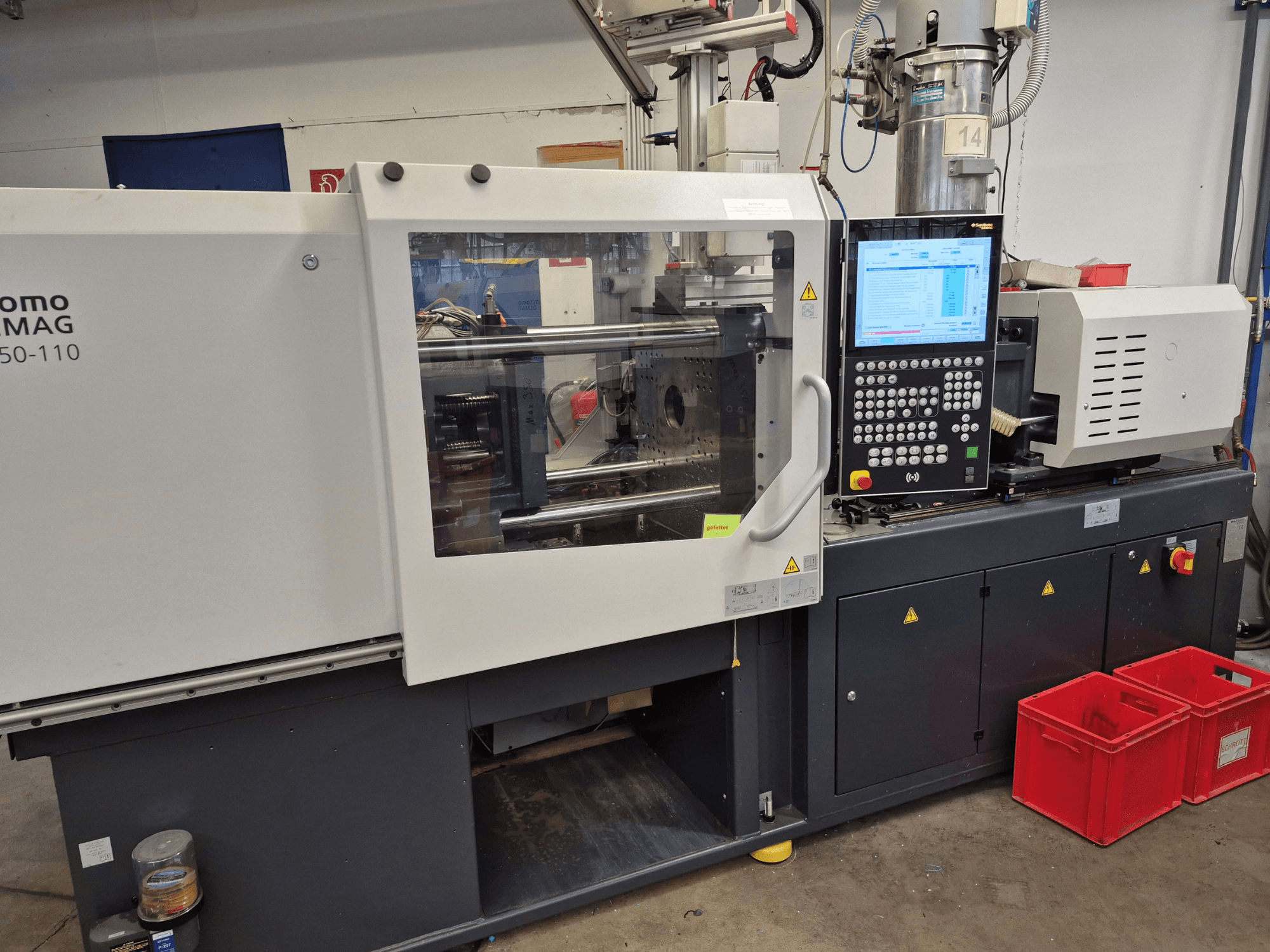 Presse à injection électrique SUMITOMO SHI DEMAG Intelect 2 50/360-110, vue de profil montrant le tableau de commande et les dispositifs de sécurité.