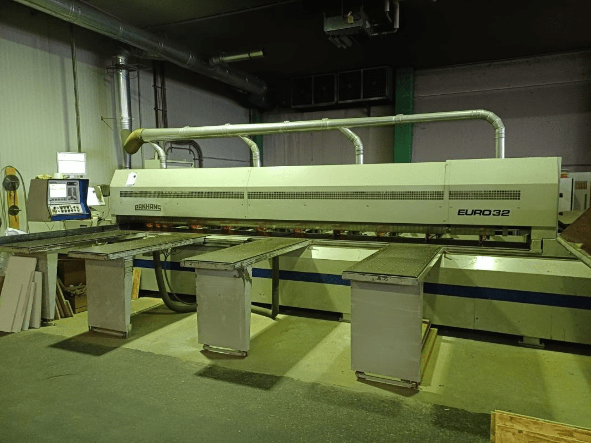 Alt text : Vue avant de la scie à panneaux PANHANS EURO 32, dotée de tables réglables et d'un panneau de commande, dans un environnement industriel.