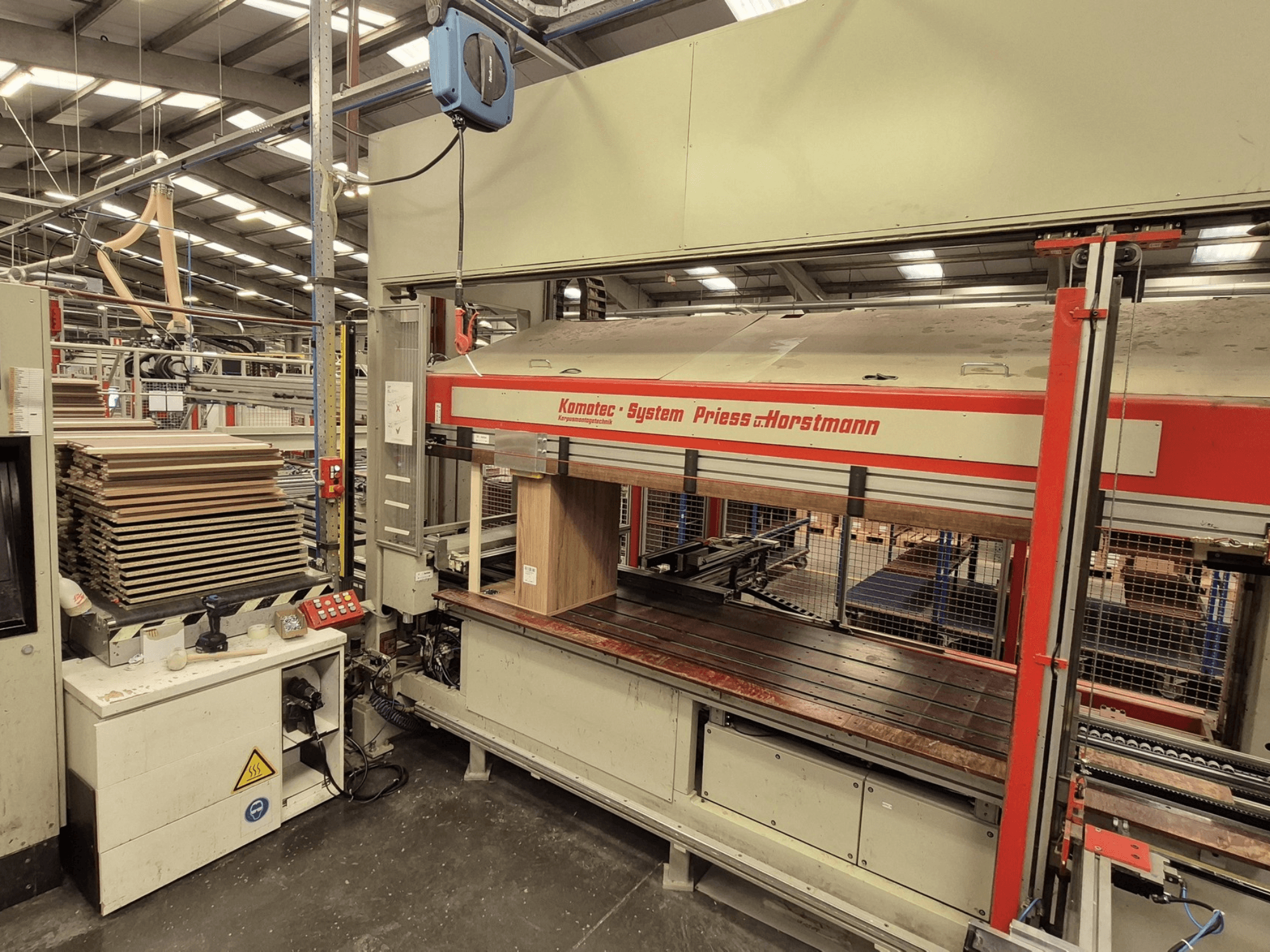 Presse à placage KP-5-CNC de PREISS U HORTSTMANN, vue de face, montrant les feuilles de placage empilées et le panneau de commande.