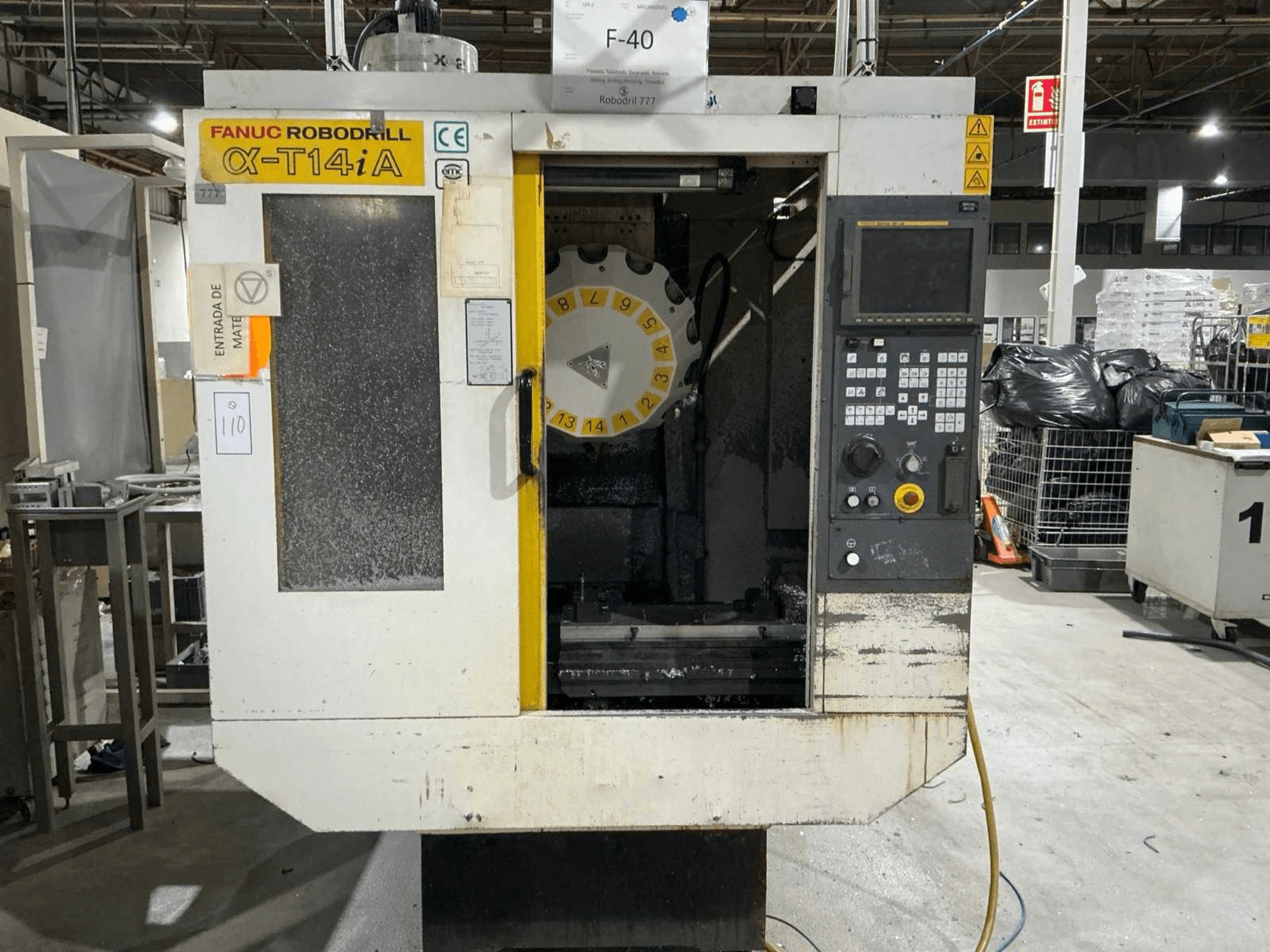 Centre d'usinage vertical FANUC ROBODRILL α-T14iB, vue de face montrant le panneau de commande et le carrousel d'outils.