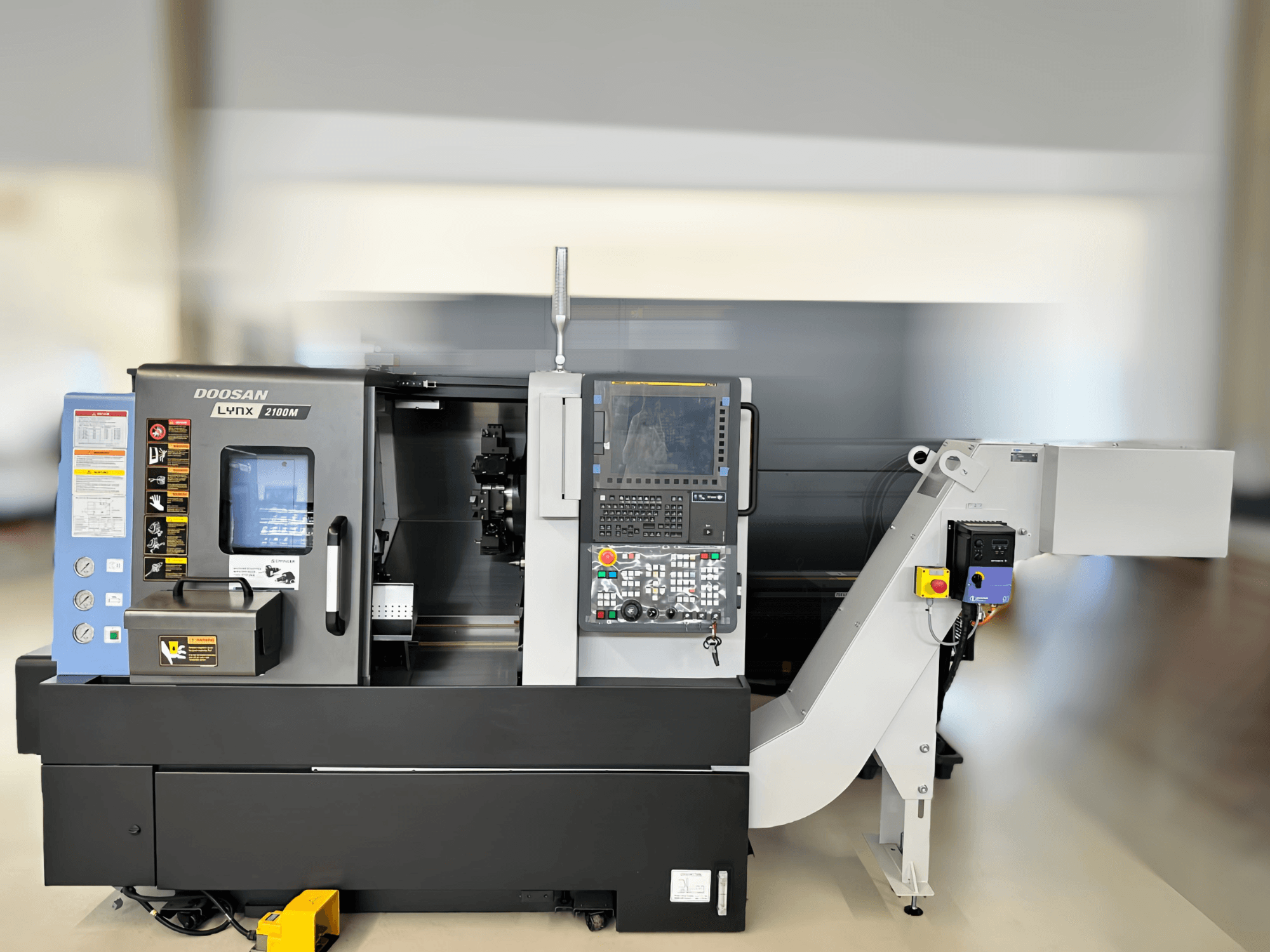 Vue avant du tour horizontal LYNX 2100MB de DN SOLUTIONS, montrant le panneau de commande et les détails de la zone de travail.