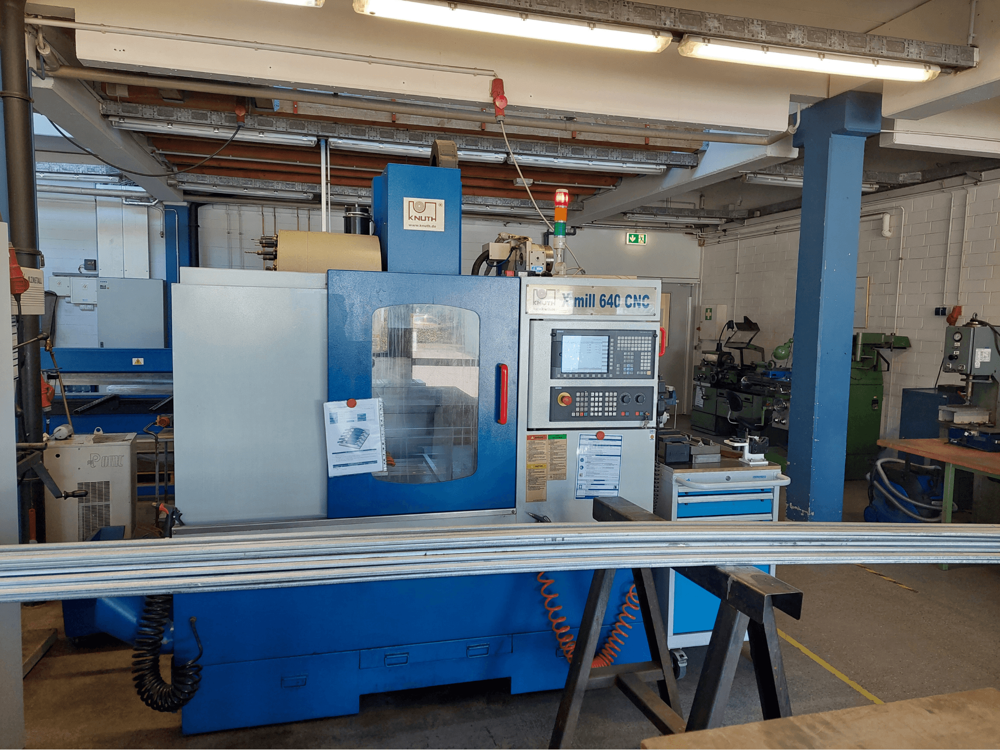 Centre d'usinage vertical KNUTH X-Mill 640, vue de face, avec son panneau de commande et sa surface de travail, dans un atelier.