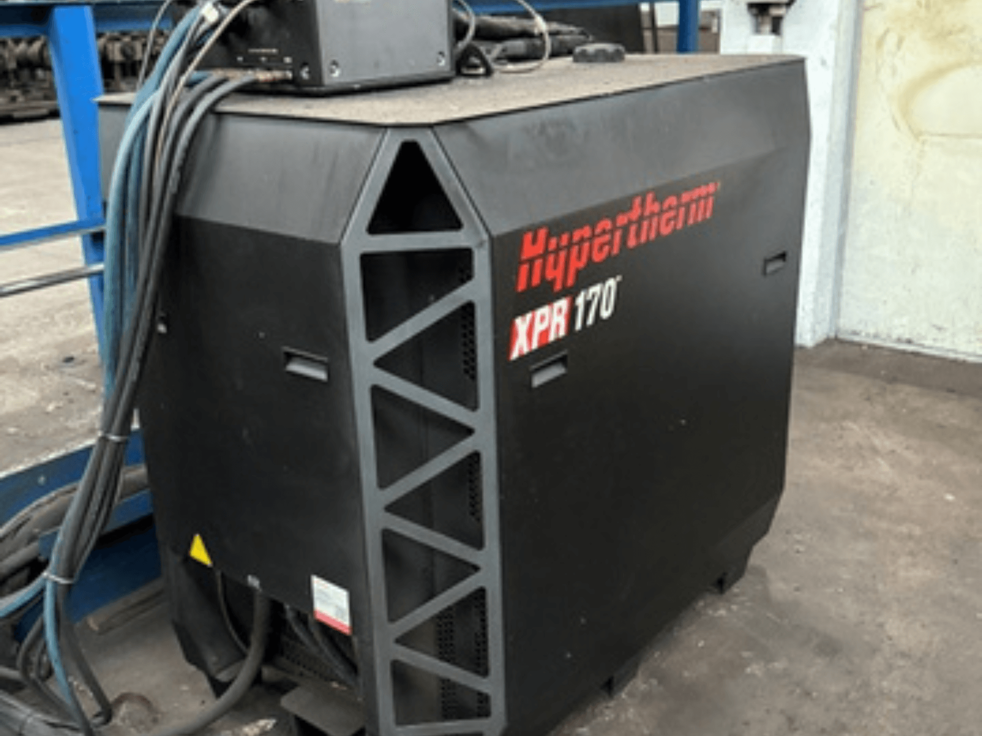 Le découpeur plasma Hypertherm XPR170, vu de côté, comporte des orifices de refroidissement et plusieurs câbles pour le fonctionnement.