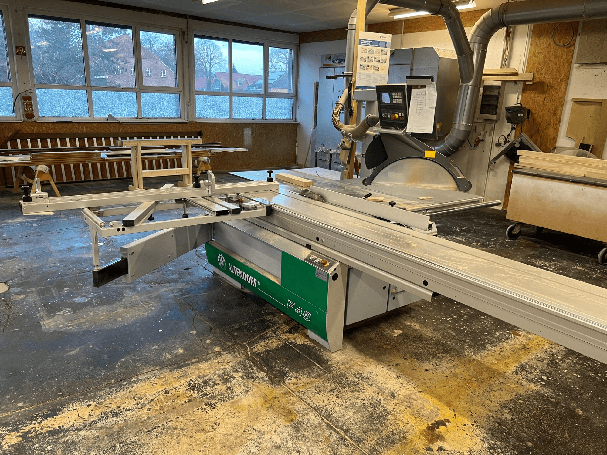 Scie à table Altendorf F45 dans un atelier, vue de face montrant le bras réglable et le panneau de commande, idéale pour les travaux de coupe de précision.