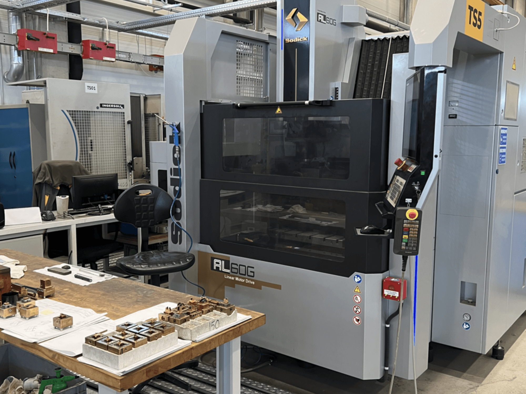 Machine d'électroérosion par enfonçage Sodick AL60G ; vue de face montrant les commandes, la fenêtre et l'espace de travail avec diverses pièces métalliques.