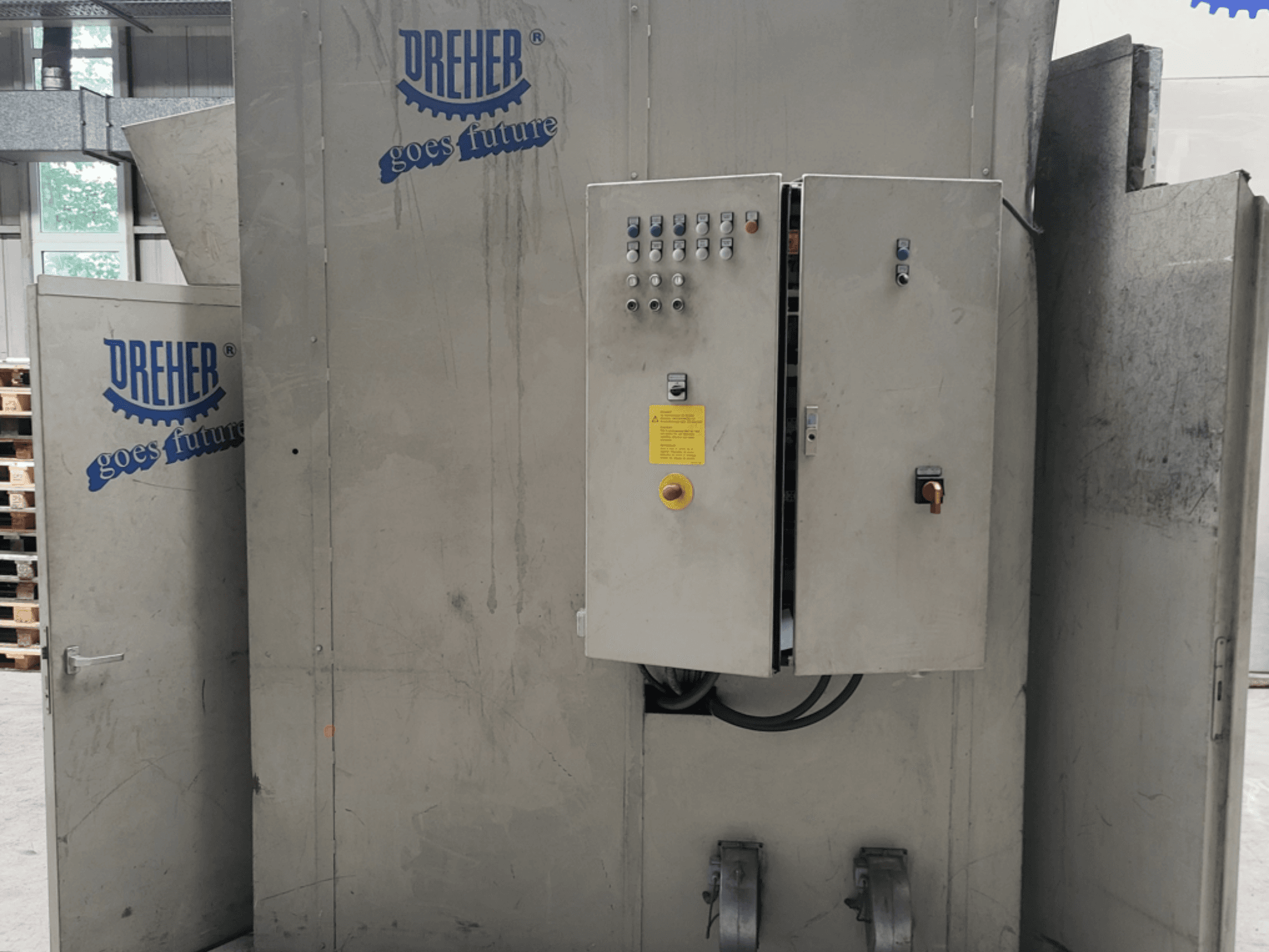 Machine de transformation des matières plastiques DREHER S 42/65 GFS-15 GR, vue de face montrant le tableau de commande et le logo, dans un environnement industriel.