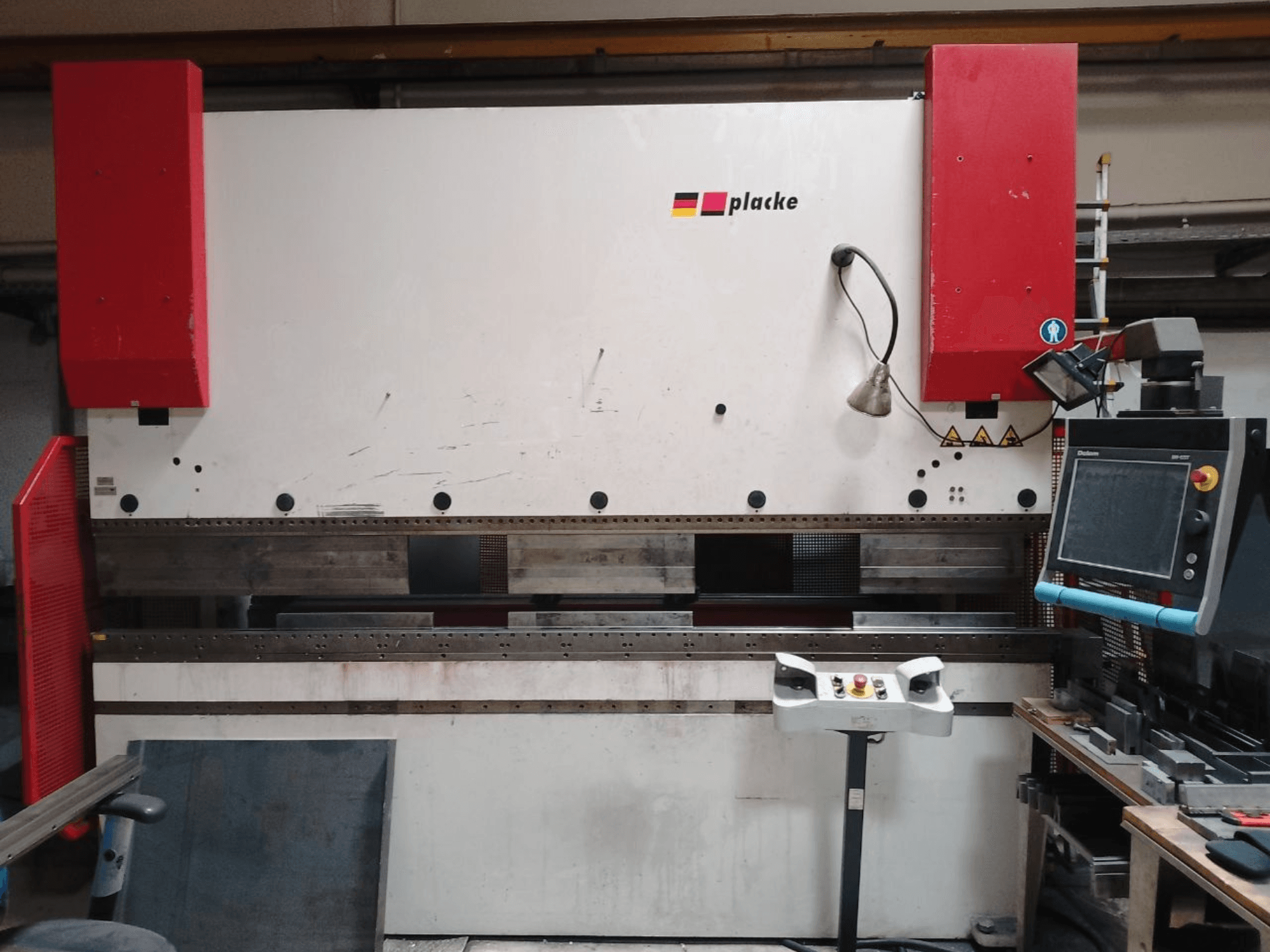 Plieuse PLACKE QPB-4 150/3100, vue de face montrant le tableau de commande, les bras rouges et la zone de pliage des métaux.