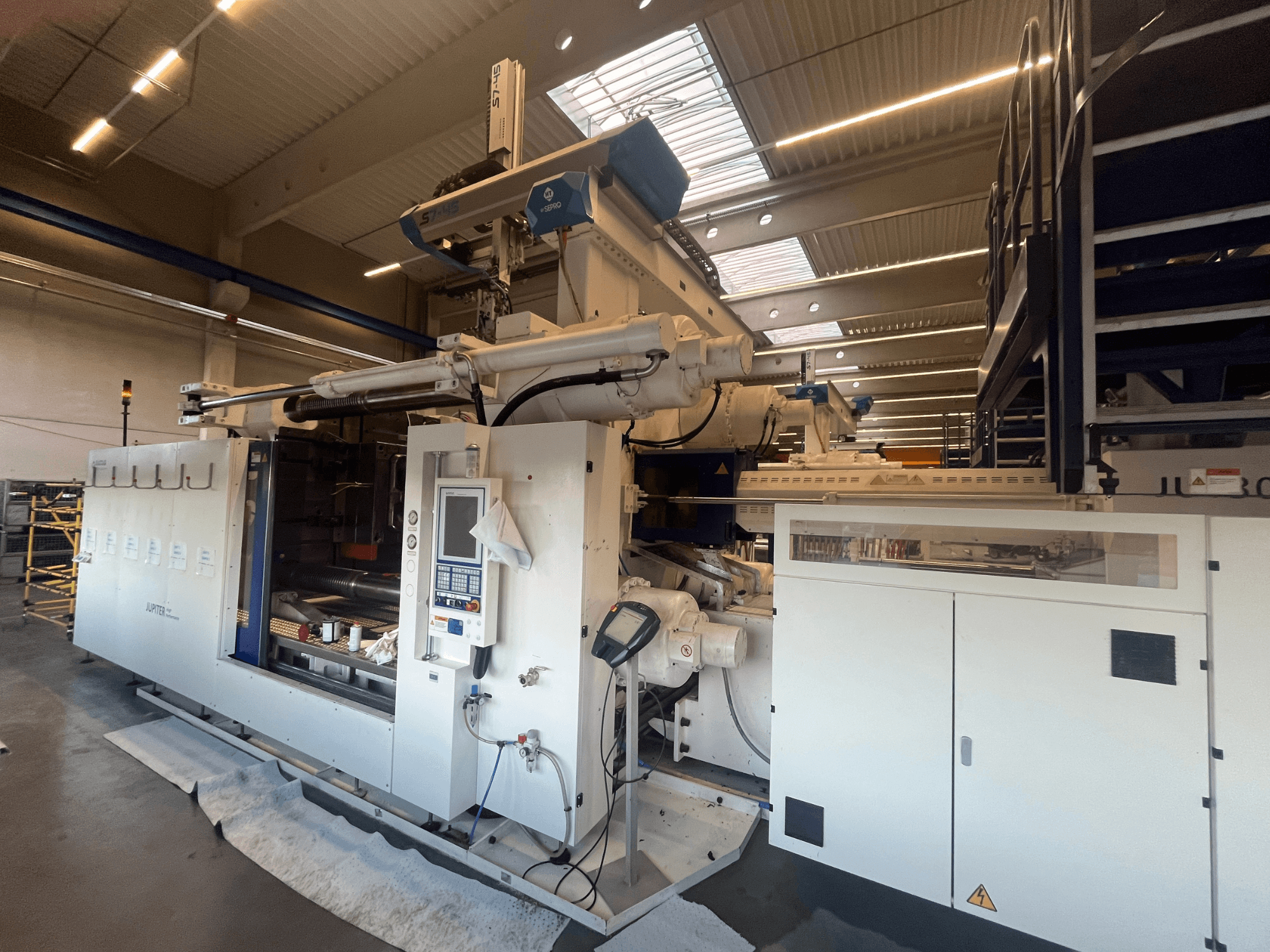 Vue de face d'une machine textile Autefa, avec panneau de commande, composants et environnement industriel.