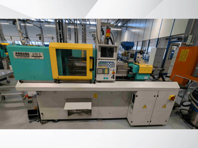 Machine de moulage par injection hydraulique Arburg 270 S 400-60, vue de face, avec le panneau de commande et les dispositifs de sécurité.