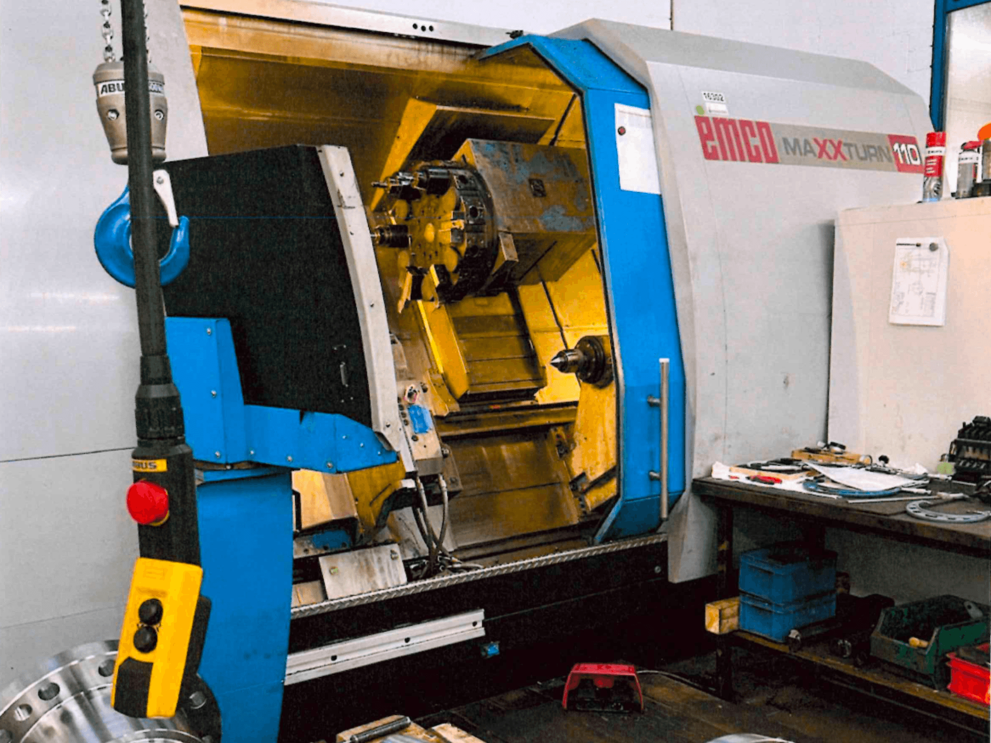 Tour horizontal EMCO MAXTURN 110, vue de face, montrant les composants internes et le panneau de commande, dans un atelier.