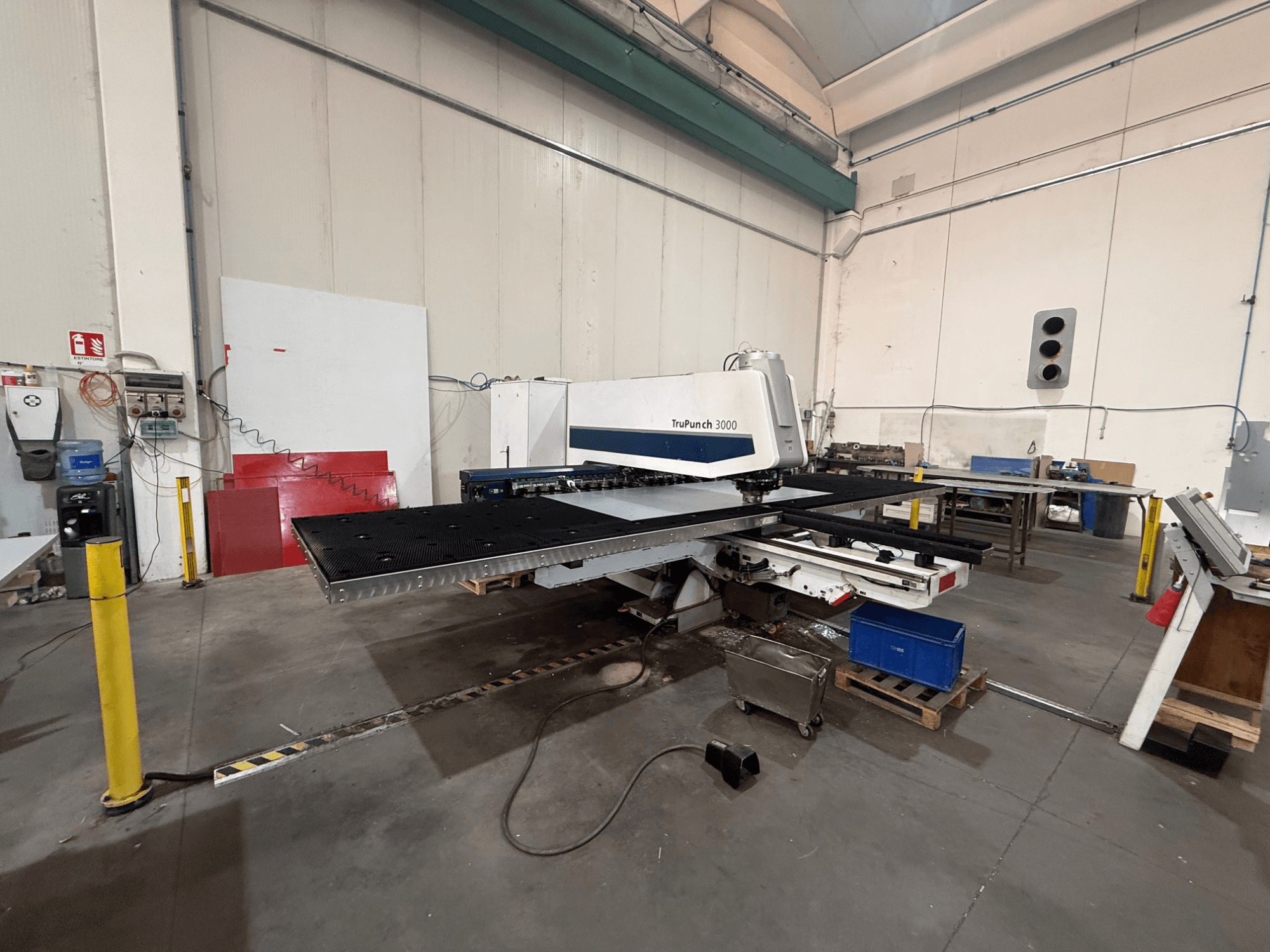 Poinçonneuse à commande numérique TRUMPF TruPunch 3000, vue de profil, montrant la tête de poinçonnage, la grande table et l'environnement de l'atelier environnant.