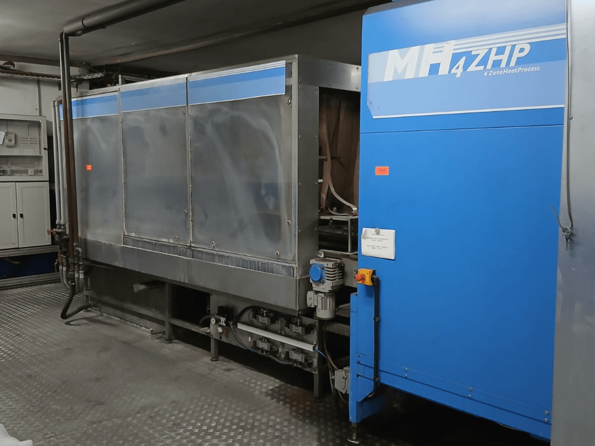 Machine industrielle MH 4ZHP vue de côté, montrant la structure en acier inoxydable et le panneau bleu avec les éléments de contrôle.